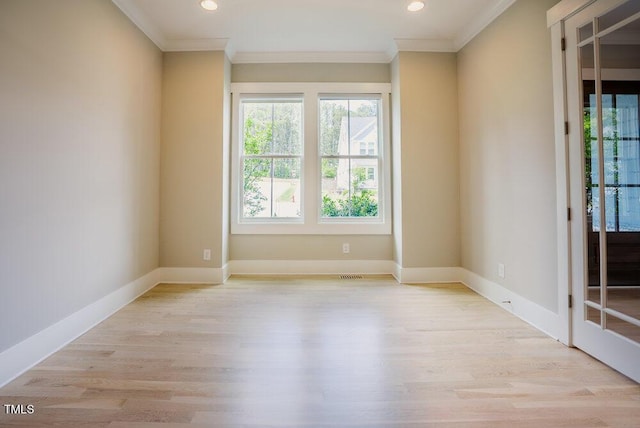 unfurnished room with healthy amount of natural light, ornamental molding, wood finished floors, recessed lighting, and baseboards