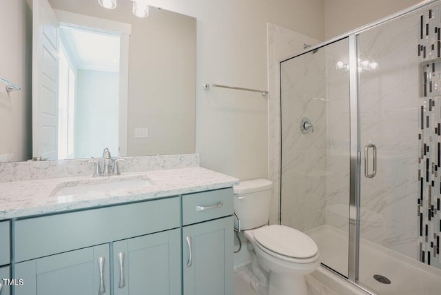 full bathroom featuring a shower stall, toilet, and vanity
