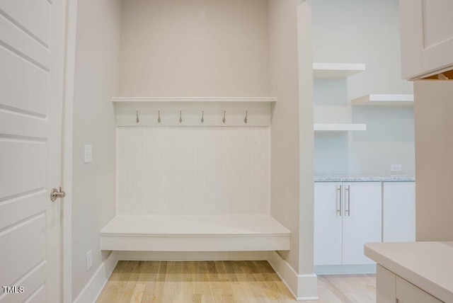 mudroom with light wood-type flooring and baseboards