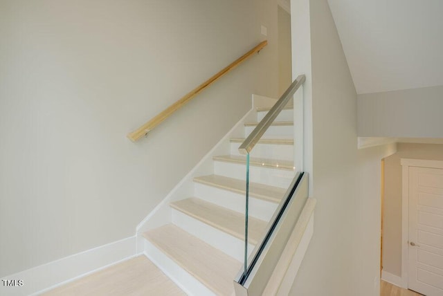 staircase with vaulted ceiling