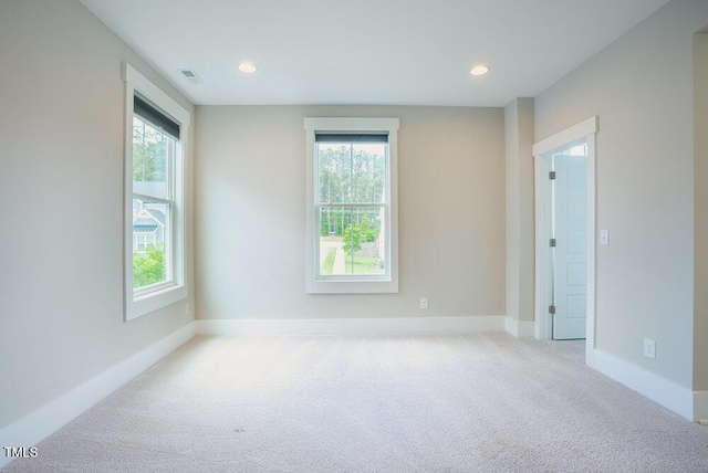 carpeted empty room featuring plenty of natural light, baseboards, and recessed lighting