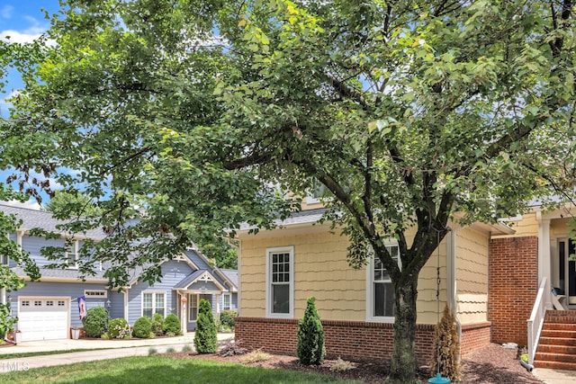 obstructed view of property featuring brick siding