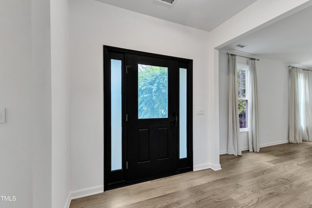 foyer with wood finished floors and baseboards