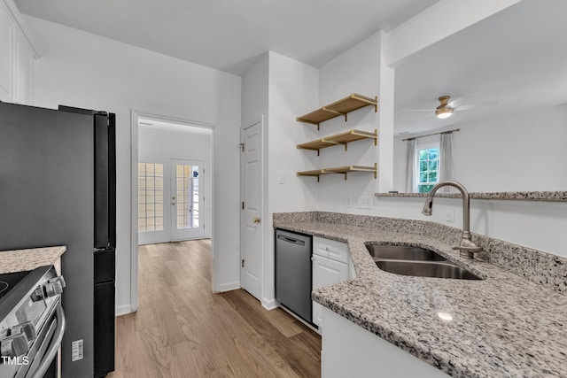 kitchen with a sink, dishwasher, stainless steel range with electric stovetop, light wood finished floors, and white cabinets