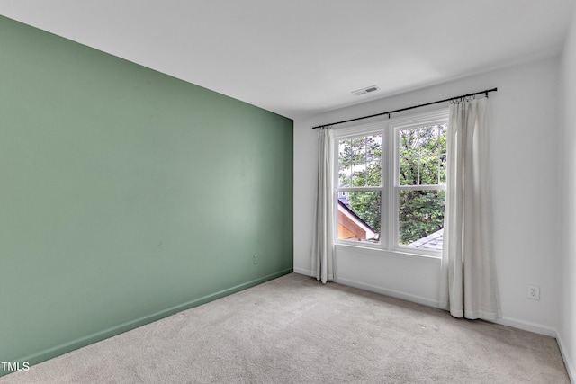 carpeted spare room with baseboards