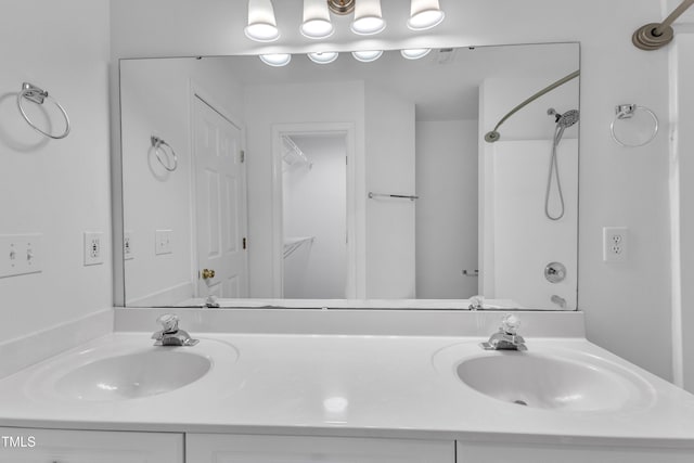 full bathroom featuring double vanity and a shower