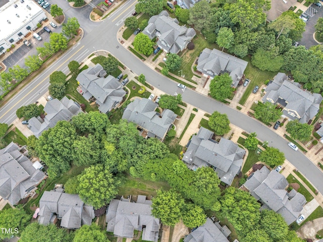 aerial view of property and surrounding area featuring nearby suburban area