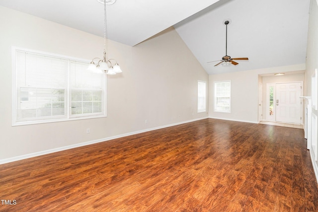 spare room featuring a chandelier, ceiling fan, wood finished floors, baseboards, and high vaulted ceiling