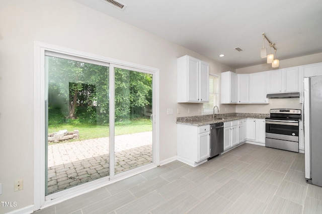kitchen with stainless steel appliances, under cabinet range hood, white cabinetry, baseboards, and light stone counters