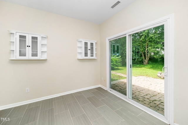 spare room with baseboards