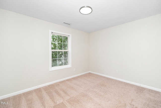 spare room with carpet and baseboards