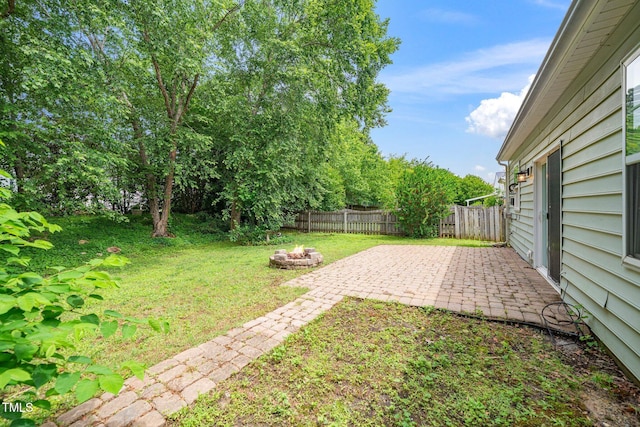 view of yard with a patio and an outdoor fire pit