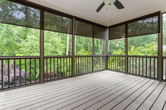 unfurnished sunroom featuring a ceiling fan