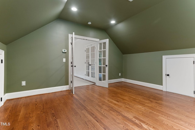additional living space featuring vaulted ceiling, french doors, baseboards, wood finished floors, and recessed lighting