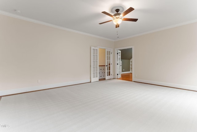 spare room featuring ornamental molding, ceiling fan, baseboards, a smoke detector, and french doors