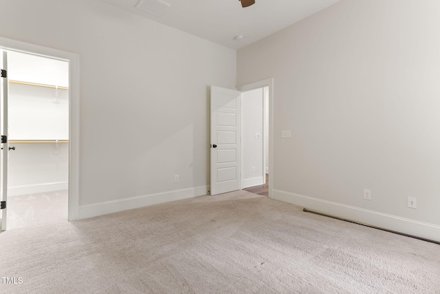 spare room with carpet flooring, a ceiling fan, and baseboards