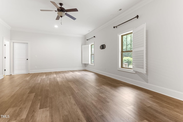 spare room featuring ornamental molding, light wood finished floors, ceiling fan, and baseboards