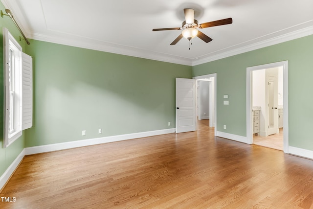 unfurnished bedroom featuring ornamental molding, light wood-style flooring, baseboards, ensuite bathroom, and a ceiling fan