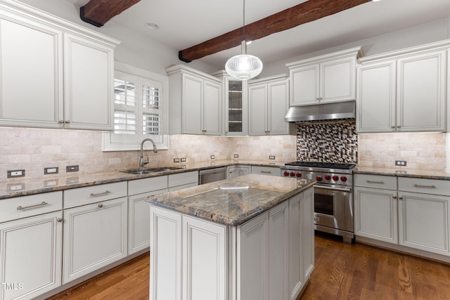 kitchen featuring appliances with stainless steel finishes, a sink, under cabinet range hood, beamed ceiling, and wood finished floors