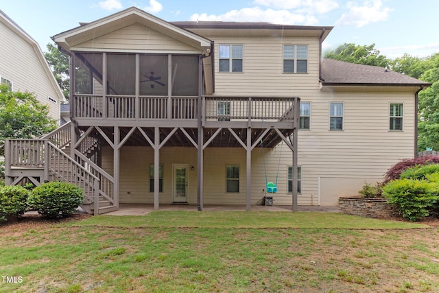 rear view of house with a sunroom, a yard, a patio area, stairway, and a shingled roof