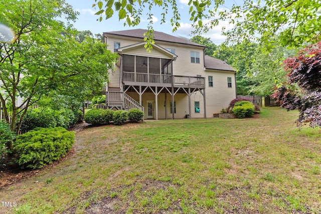 rear view of house featuring a sunroom, stairway, roof with shingles, and a deck