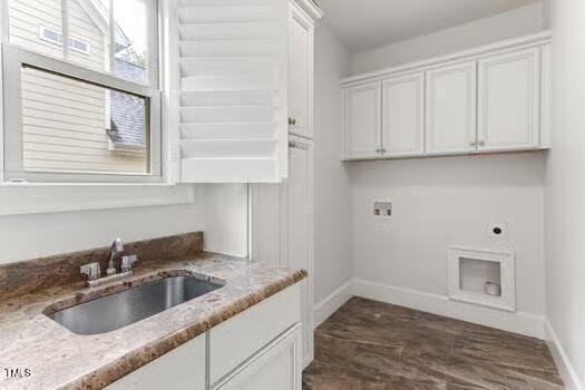 washroom featuring baseboards, cabinet space, washer hookup, and electric dryer hookup