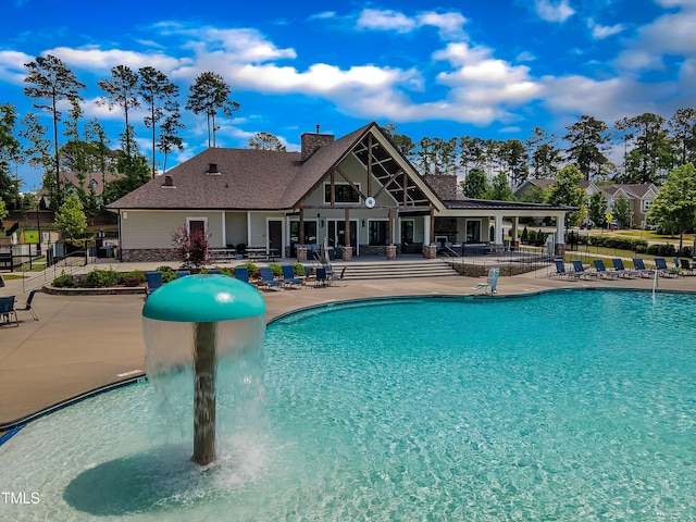 community pool with a patio and fence