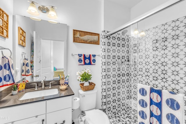 bathroom featuring a shower stall, vanity, and toilet