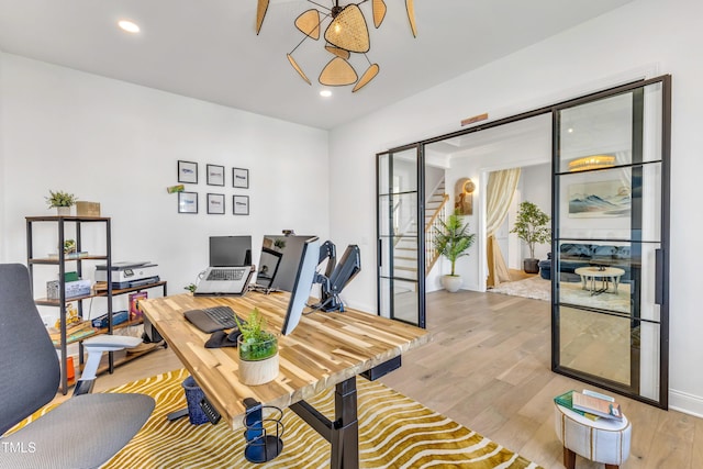 office area with light wood finished floors, recessed lighting, and baseboards