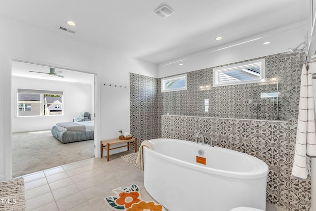 bathroom with a freestanding tub, tile patterned floors, recessed lighting, and ensuite bathroom