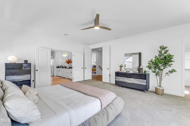 bedroom featuring ornamental molding, light carpet, baseboards, a ceiling fan, and ensuite bath