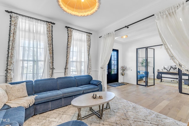 living room featuring wood finished floors and crown molding