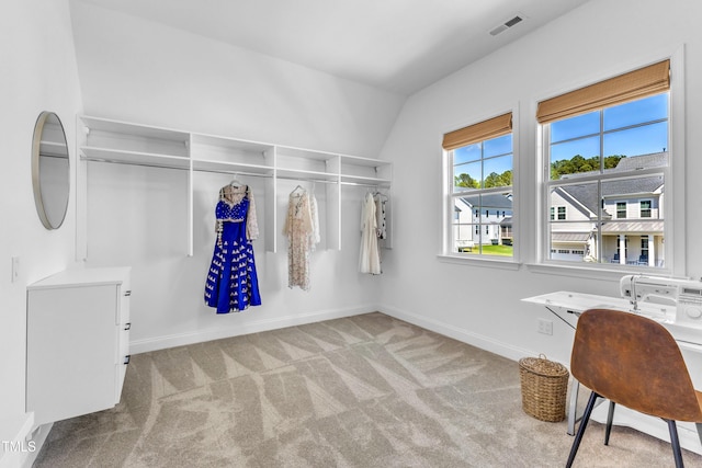 walk in closet featuring carpet and vaulted ceiling