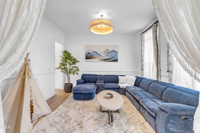 living room with ornamental molding and wood finished floors