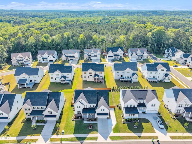 aerial view of residential area featuring a forest