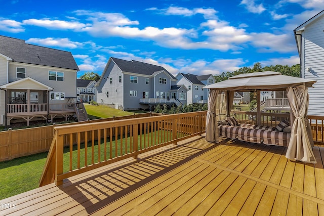 wooden deck with a residential view and a gazebo