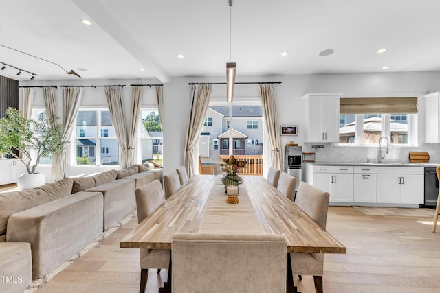 dining room featuring light wood-type flooring and recessed lighting