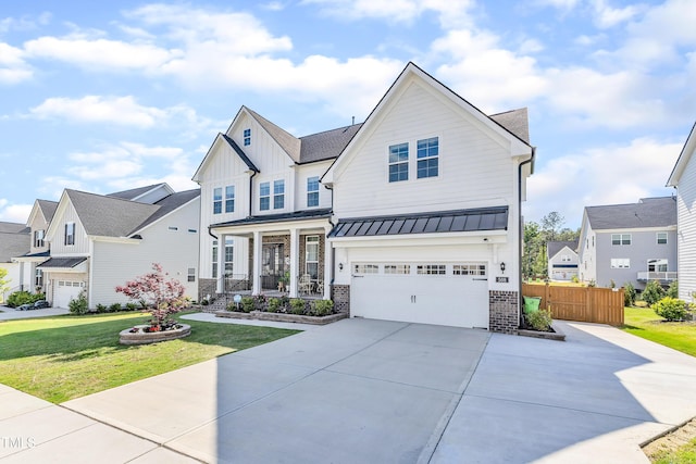 view of front of house featuring a standing seam roof, concrete driveway, board and batten siding, a garage, and a porch