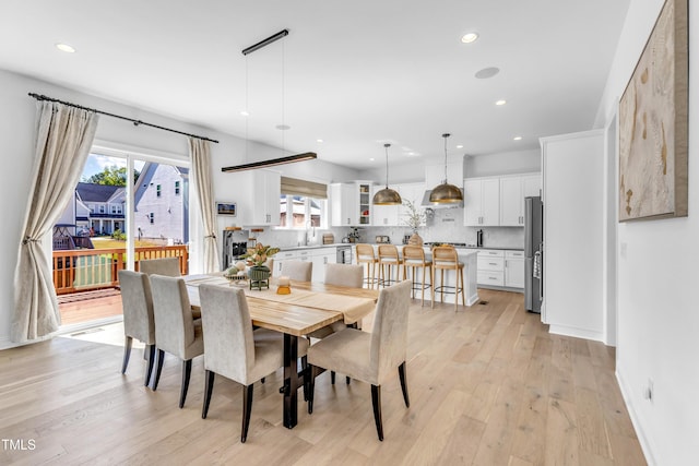 dining area with recessed lighting, plenty of natural light, light wood-style flooring, and baseboards