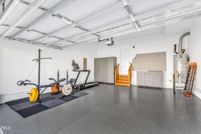 garage with gas water heater, a garage door opener, and baseboards