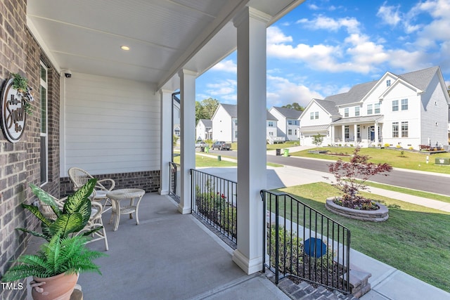 view of patio featuring covered porch and a residential view