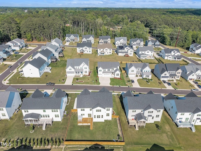 aerial view of residential area featuring a heavily wooded area