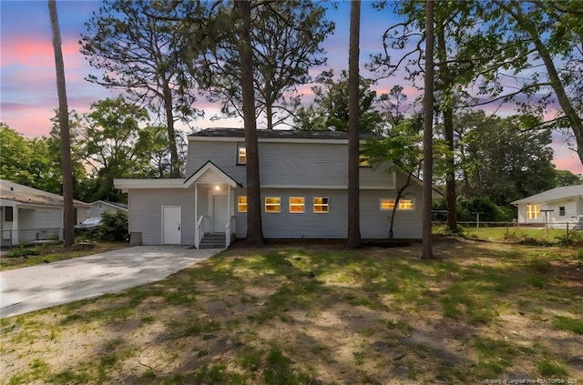 view of front of home with fence and driveway