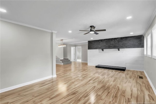 unfurnished living room featuring ornamental molding, ceiling fan, baseboards, stairway, and light wood finished floors