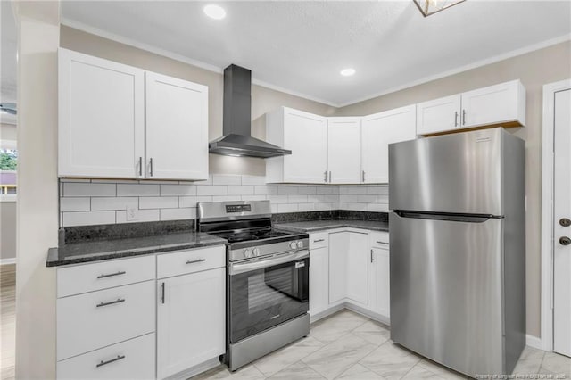 kitchen with stainless steel appliances, wall chimney range hood, white cabinets, light marble finish flooring, and crown molding
