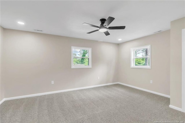 carpeted spare room with healthy amount of natural light, baseboards, ceiling fan, and recessed lighting