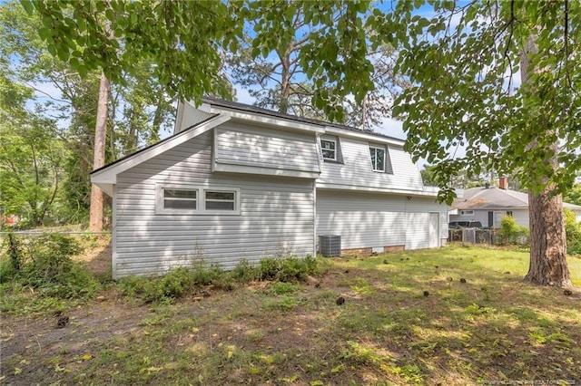 back of house featuring fence and central AC unit