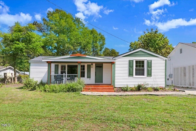 view of front of home with a porch and a front yard