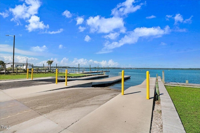 dock area with a boat ramp and a water view