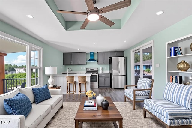 232 Fulcher Landing Rd, Sneads Ferry, NC 28460 - living area featuring wood finished floors, ceiling fan, a tray ceiling, and recessed lighting